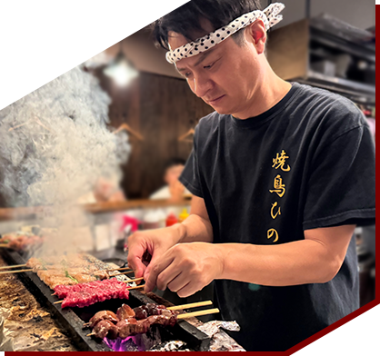 owner Masashi Nabeta grilling skewers